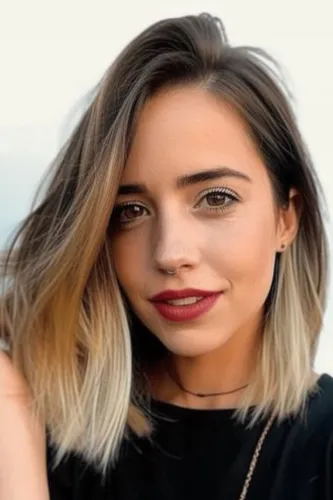 Try on a trendy ombre hairstyle with medium length hair, featuring shades blending from dark roots to lighter tips.