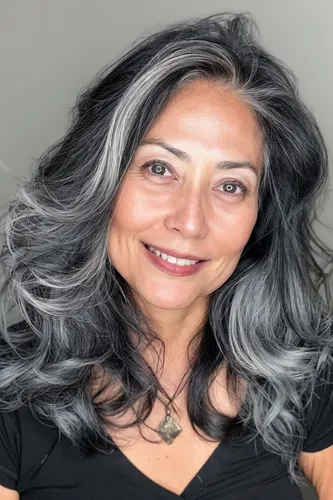 Try on this stylish wavy ombre hairstyle featuring shades of gray and black, flowing loosely for a modern and chic look.