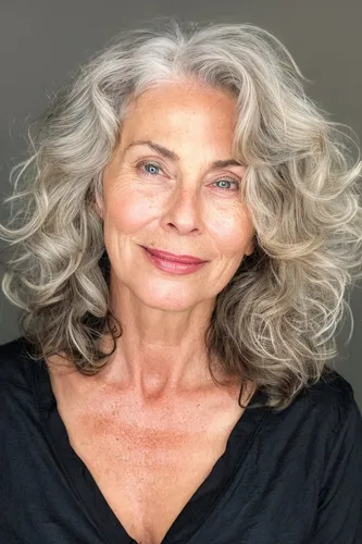 Try on this luxurious silver-gray wavy hairstyle, flowing effortlessly with natural volume and curls, imparting a graceful and dignified look.