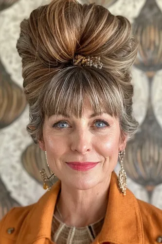 Try on this elaborate updo hairstyle with bangs framing the face, accentuated by a subtle accessory placement that enhances the volume at the top. This hairstyle is ideal for formal events or a stylish day out.