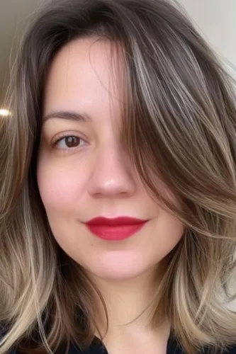 Try on this medium-length ombre hairstyle featuring a blend of dark to lighter tones towards the ends, providing a soft gradient effect.