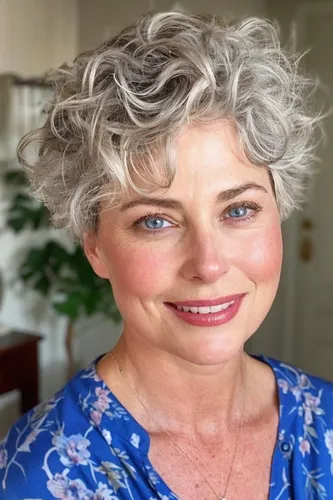 Try on a short curly hairstyle characterized by tight curls and a voluminous look.