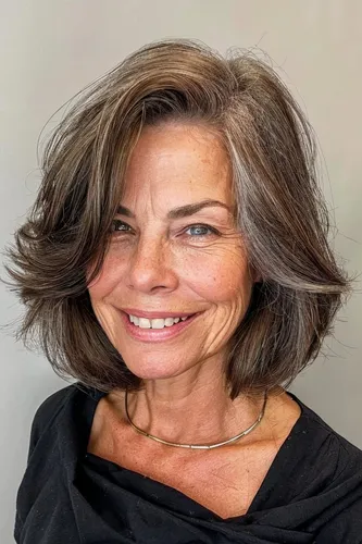 Try on this stylish wavy short hairstyle that elegantly frames the face, featuring soft layers and a natural blend of brown tones.