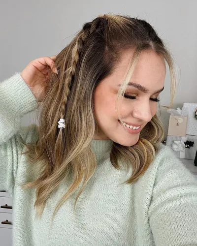 Try on this hairstyle featuring a mix of braided and wavy textures.