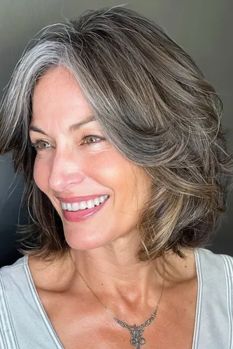 Try on a stylish short, wavy hairstyle with natural gray and brown tones
