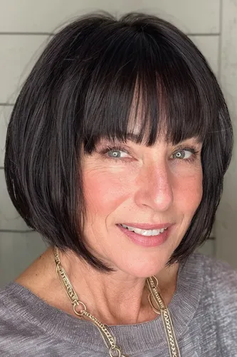 Try on the classic bob cut with sleek bangs covering the forehead, neatly styled to enhance facial features.
