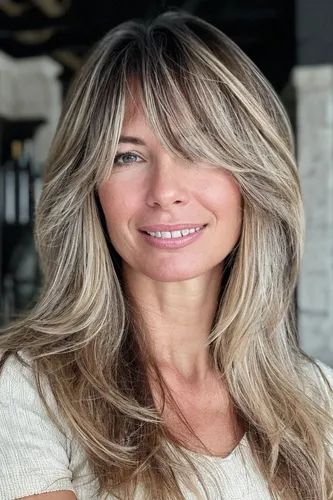 Try on this long layered hairstyle with blonde highlights that adds texture and dimension.