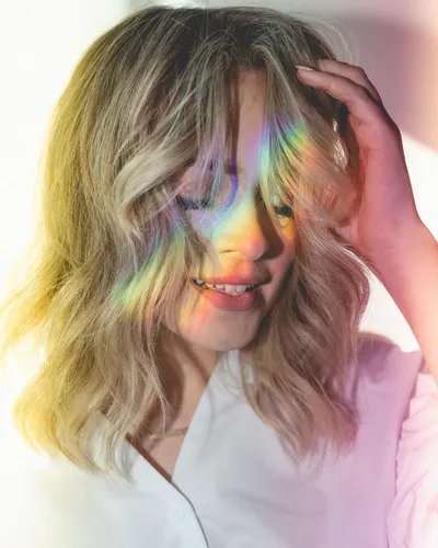 Try on a natural, wavy, blonde hairstyle with medium-length hair.