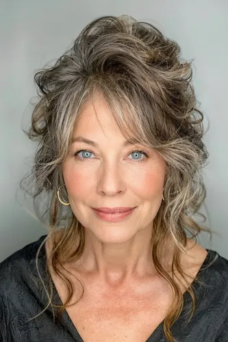 Try on this hairstyle featuring loose, messy curls in light brown with some subtle highlights. The hair is textured and voluminous, enhancing a carefree and relaxed vibe.