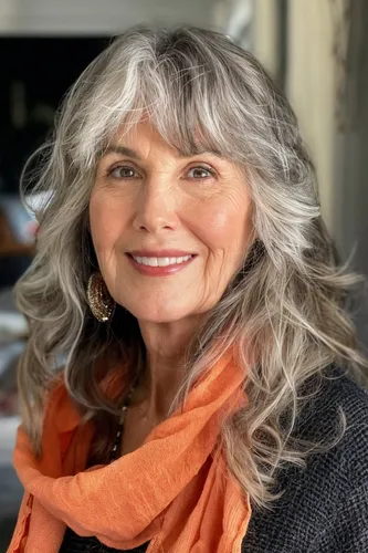 Try on this elegant wavy, salt-and-pepper hairstyle that gracefully mixes gray and white tones.