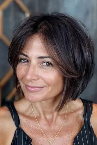 Try on this short, layered bob hairstyle that frames the face elegantly, highlighting playful texture and volume.