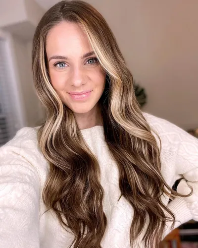 Try on this look: long wavy hairstyle with blonde highlights.