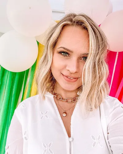 Try on a shoulder-length, tousled wavy hairstyle like the one in the image for a fresh and playful look.