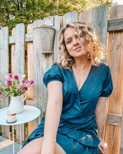 Try on a hairstyle with curly, medium-length hair, characterized by loose, voluminous curls that add a playful charm.