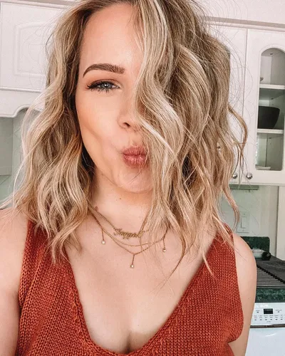 Try on this playful wavy hairstyle, featuring loosely curled strands that add a touch of casual elegance.
