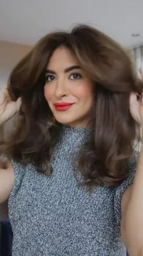 Try on this voluminous wavy brown hairstyle, ideal for adding a touch of elegance.
