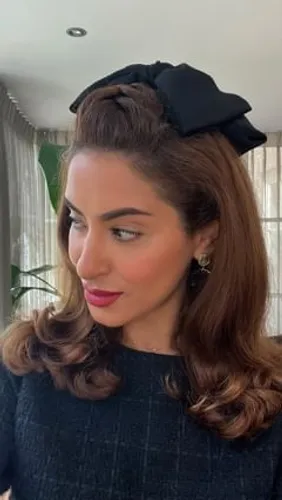 Try on this elegant hairstyle featuring voluminous curls at the ends and a chic black headband accentuating the crown.