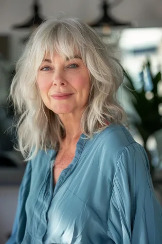 Try on this dynamic long, wavy hairstyle showcased by a mature woman, giving a graceful and attractive appearance