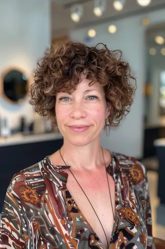 Try on a curly hairstyle, featuring bouncy and well-defined curls that add volume around the head.