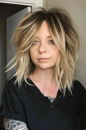 Try on a medium-length wavy, layered hairstyle with highlights, offering a casual yet stylish look.