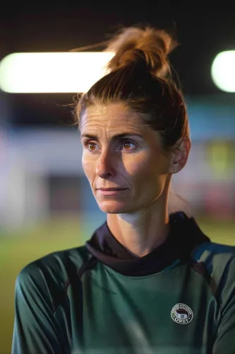 Try on a casual messy bun hairstyle, suitable for sporty or informal settings.