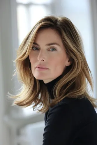 Try on a long wavy hairstyle as seen on the woman in the image, which drapes elegantly with soft curls.