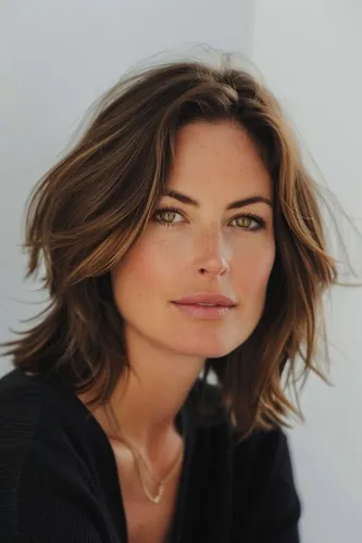 Try on a shoulder-length, wavy hairstyle with light and dark brown tones, giving a dynamic and voluminous appearance.
