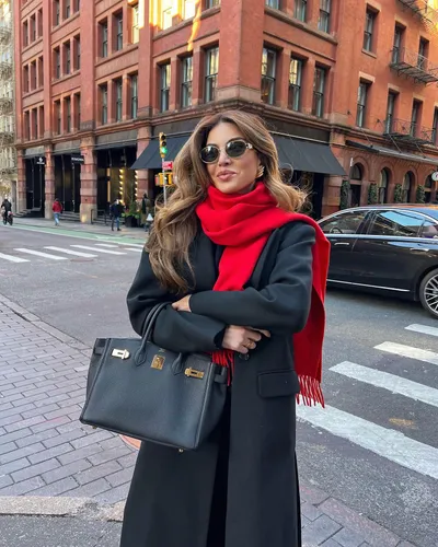 Try on this hairstyle: A woman with long, voluminous, slightly waved hair styled with a center part.