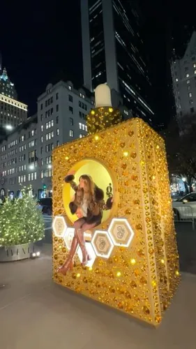 Try on this long wavy hairstyle, as demonstrated by the person posing inside a decorative oversized prop.