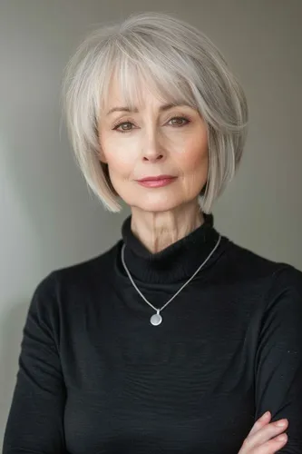 Try on this elegant short gray hairstyle featuring soft layers that frame the face gently. This style can add a youthful yet sophisticated charm, perfect for a poised look.