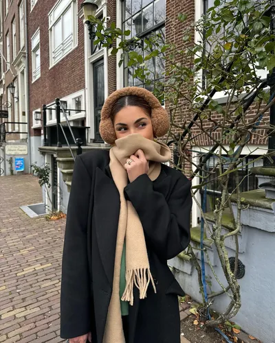 Try on a covered hairstyle, obscured by a fluffy headband, creating an elegant and cozy look perfect for cooler weather.