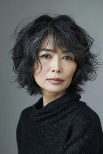 Try on this chic short wavy hairstyle in layers that enhance the natural grey hues.