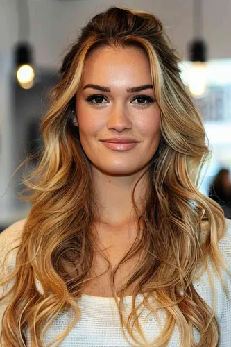 Try on this lovely long, wavy hairstyle that cascades gracefully down the shoulders, featuring natural highlights and soft waves for a charming, effortless look.
