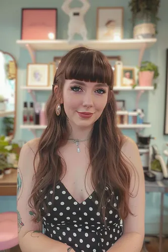 Try on this hairstyle featuring straight bangs across the forehead and long wavy locks.