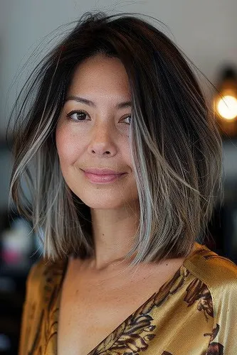 Try on this stylish ombre lob hairstyle featuring dark roots fading into light blonde tips.