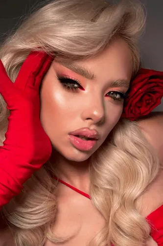 Try on this glamorous blonde wavy hairstyle for a captivating look. The hairstyle features voluminous curls, adding a touch of elegance and sophistication.