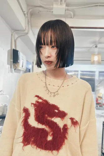 Try on a sleek, straight bob haircut that reaches just below the jawline, showcasing a well-defined, neat look.