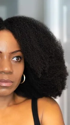 try on an afro hairstyle, featuring voluminous and textured curls