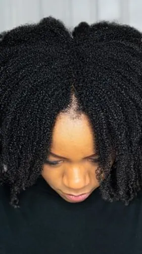 Try on a twist-out hairstyle featuring densely packed, coiled hair sections, offering a highly textured appearance.