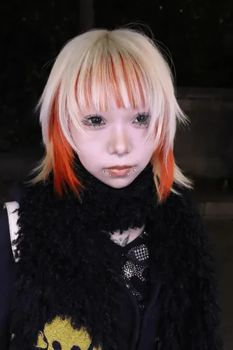 Try on a hairstyle featuring short, layered hair with blonde, red, and orange hues