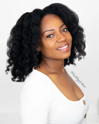 Try on this voluminous curly hairstyle, featuring lush, dense curls that flow gracefully.