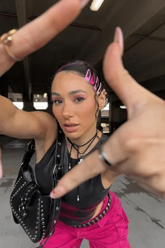 Try on a hairstyle featuring tightly braided hair with pink highlights and playful pink clips spelling out 'DOLL'