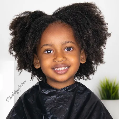 Try on the natural and curly hairstyle, featuring voluminous and textured afro curls.