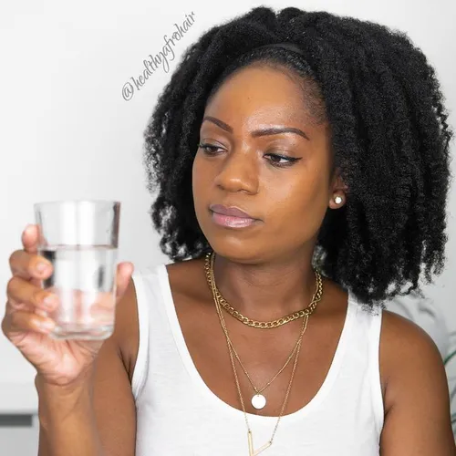 Try on a natural, curly hairstyle with medium length and well-defined curls.