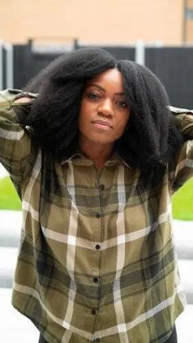 Try on this voluminous long afro hairstyle, featuring a full, thick texture that frames the face beautifully.