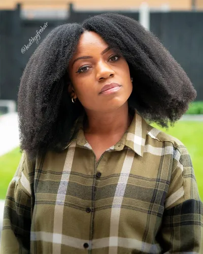 Try on this chic afro-textured, shoulder-length hairstyle perfect for a stylish look.