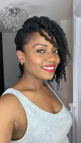 Try on this beautiful twist out hairstyle, intricately arranged in tight, voluminous curls that are partially pinned up on one side, offering a stylish and chic look.