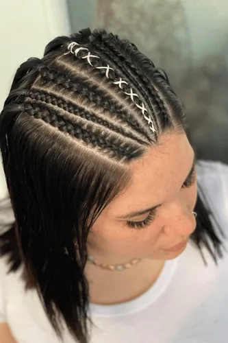 Try on this hairstyle featuring tightly woven cornrows at the top of the head, transitioning into loose waves flowing down the sides.