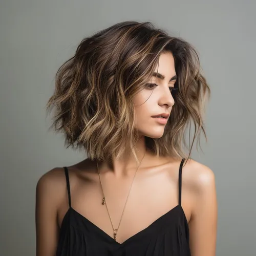 Try on this stylish wavy, medium length hairstyle that gives a voluminous and dynamic look, perfect for a modern chic appearance.