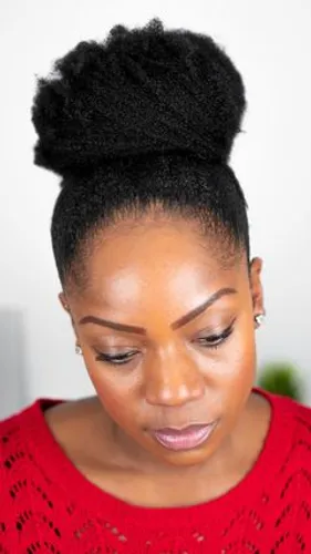 Try on this elegant high bun hairstyle, beautifully styled atop the head with a neat and controlled texture.